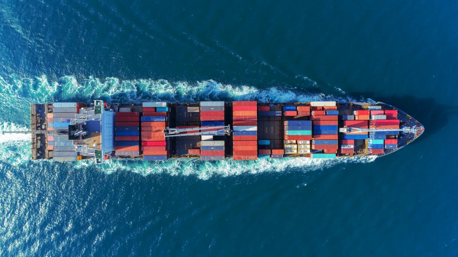 Aerial view of a container ship being loaded at port